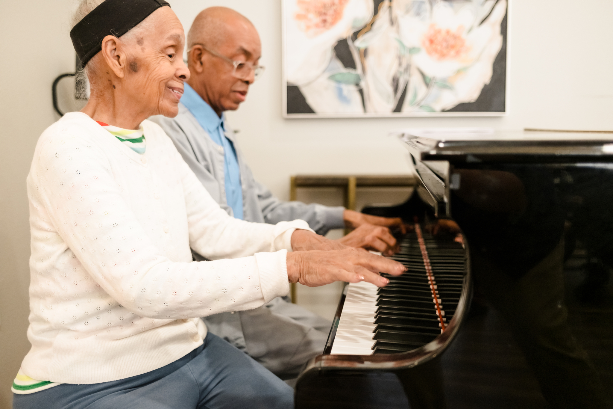 Resident at Grand Brook playing piano
